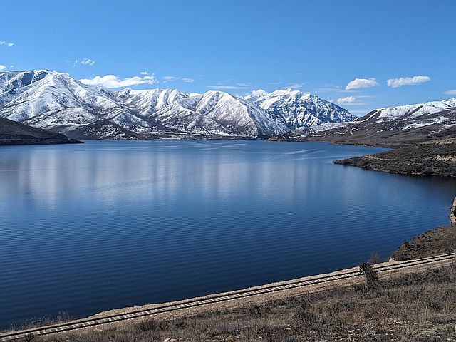 nice view of lake and mountains with snow